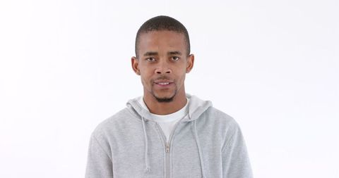 Young Man in Hoodie Displaying Anger with Intense Expression