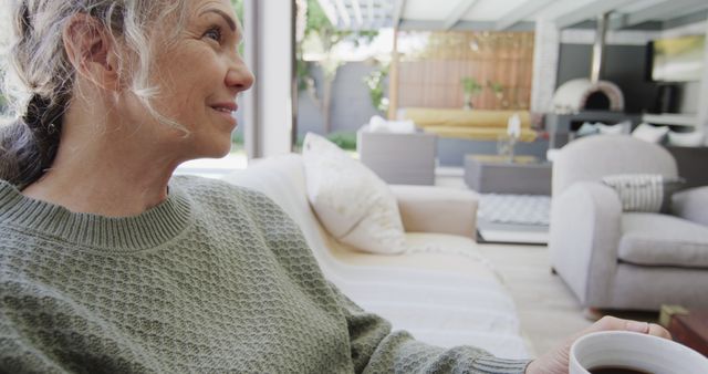 Elderly Woman Relaxing with Coffee in Modern Outdoor Living Space - Download Free Stock Images Pikwizard.com