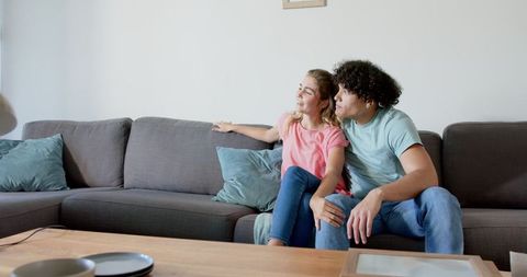 Couple Relaxing on Plush Sofa in Minimalist Home Interior
