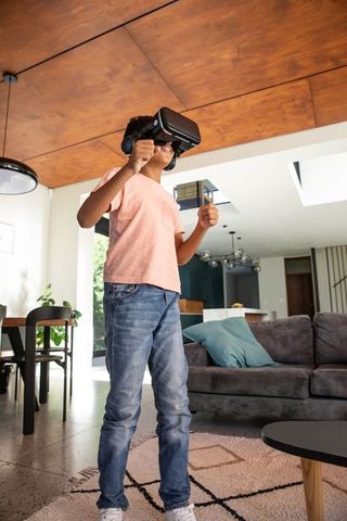 Afro-american child immersed in virtual reality headset