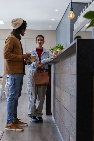 African american couple sharing coffee at modern minimalist cafe counter, urban lifestyle
