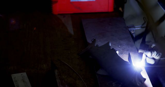 Worker Welding Metal in Dark Workshop - Download Free Stock Images Pikwizard.com