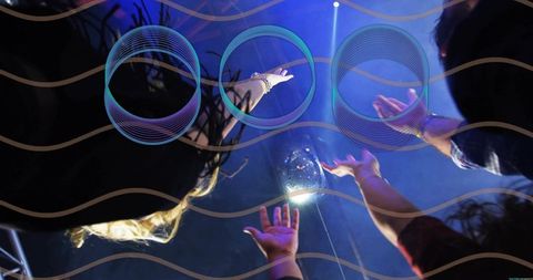 Crowd reaching toward suspended orb nightclub blue purple lights neon glow