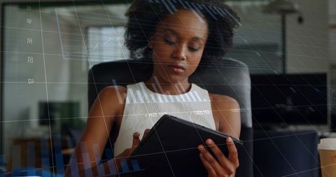 Professional reviewing tablet with financial charts overlay for remote work productivity