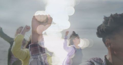 Diverse Women Raising Hands in Unison Against Light Spots