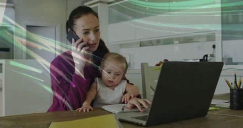 Busy parent juggling newborn and remote work at kitchen table, multitasking with laptop