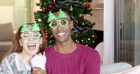 Couple Wearing Novelty Glasses in Festive Christmas Atmosphere