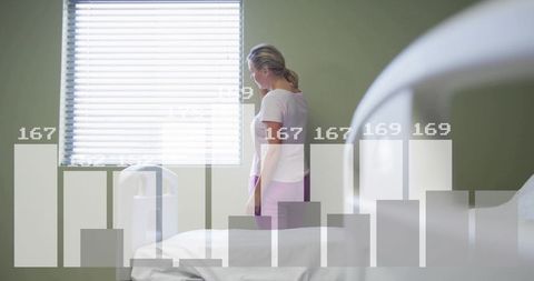 Standing female patient by imaging scanner in diagnostic room with data overlay