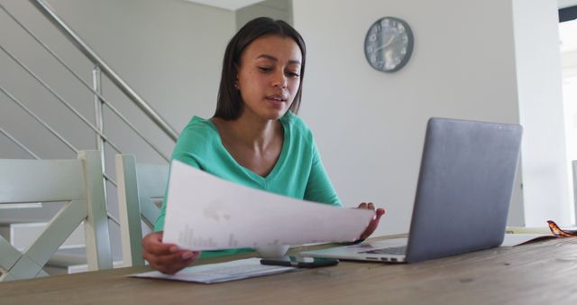 Focused woman working remotely at home office desk on laptop - Download Free Stock Images Pikwizard.com