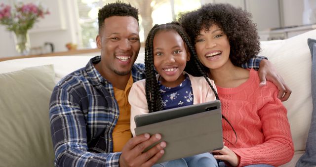 Happy African American Family Watching Tablet Together on Couch - Download Free Stock Images Pikwizard.com