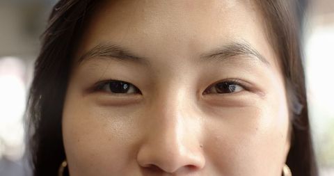 Close-Up Portrait of Asian Woman Showcasing Skin Texture Indoors