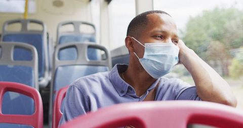 Pensive Man in Face Mask on City Bus During COVID-19 - Download Free Stock Images Pikwizard.com