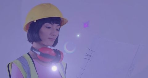 Engineer reviewing plans with futuristic light trails