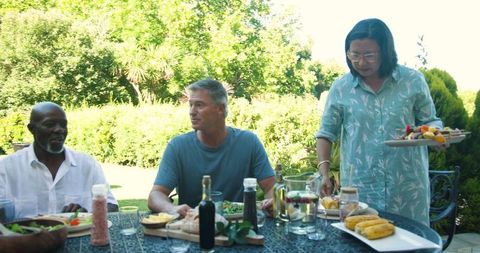 Diverse group enjoying al fresco dining experience on sunny day