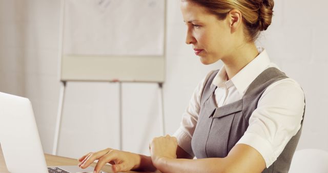 Professional Woman Working on Laptop in Office Setting - Download Free Stock Images Pikwizard.com