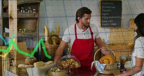 Artisanal Bakery Serving Male Baker in Red Apron with Rustic Bread, Wicker Baskets