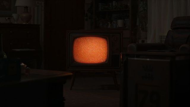 Vintage crt television emitting orange static in retro room