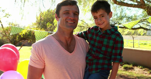 Smiling Father and Son at Outdoor Birthday Party with Balloons and Decorations - Download Free Stock Images Pikwizard.com