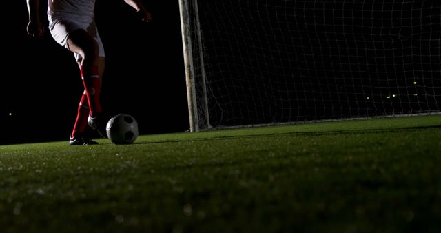Soccer Player Preparing To Strike Ball During Night Match - Download Free Stock Images Pikwizard.com
