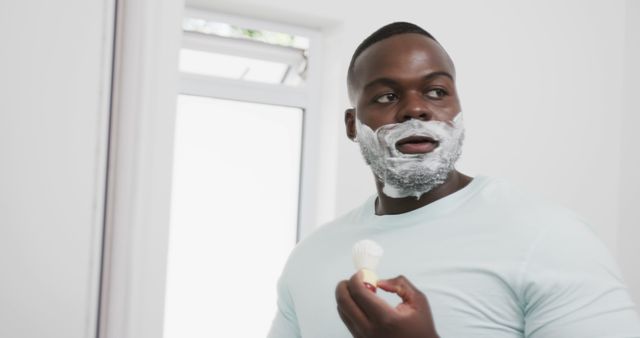 Man Shaving Beard with Shaving Brush in Bathroom - Download Free Stock Images Pikwizard.com