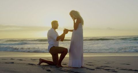 Sunset beach proposal with ocean waves
