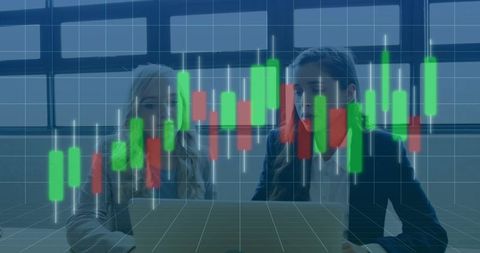 Business team analyzing candlestick trading chart on laptop during finance meeting