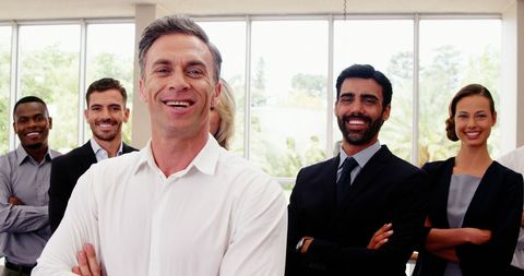 Confident Business Team in Office Environment Smiling Together - Download Free Stock Images Pikwizard.com