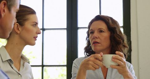 Business Professionals Conversing Over Coffee in Office - Download Free Stock Images Pikwizard.com