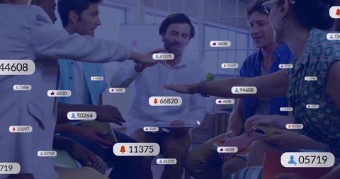 Collaborating startup team huddling around tablets with social media notification overlays