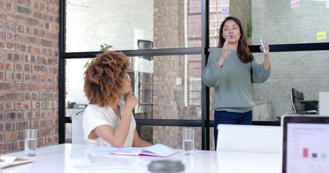 Diverse Businesswomen Collaborating and Planning in Modern Office