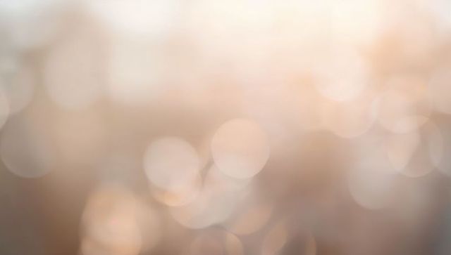 Glowing abstract bokeh lights creating soft warm golden orbs and dreamy lens flare