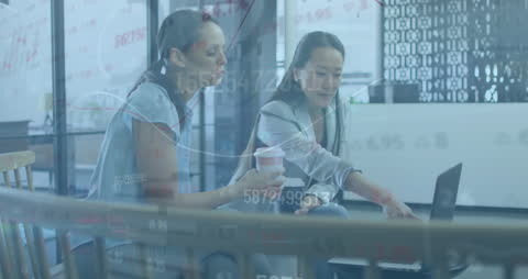 Collaboration in Modern Office Amid Financial Data Visuals