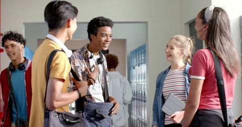 Teenagers Conversing Joyfully in High School Hallway - Download Free Stock Images Pikwizard.com