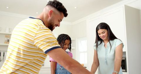 Family enjoying baking activity in modern kitchen setting