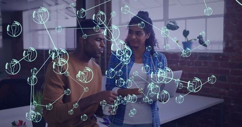 Colleagues analyzing network data with digital overlay