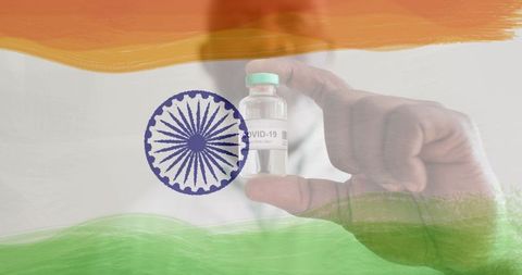 Doctor holding covid-19 vaccine against indian flag background
