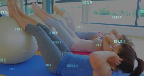 Group exercise with stability balls in modern fitness studio