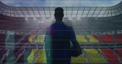 Rugby Player Analyzing Game Data At Stadium With Futuristic Graphs