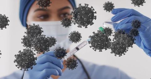 Nurse drawing vaccine from vial wearing mask and gloves with virus graphic overlay