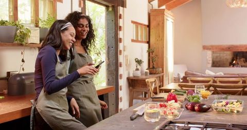 Diverse friends cooking together in rustic kitchen