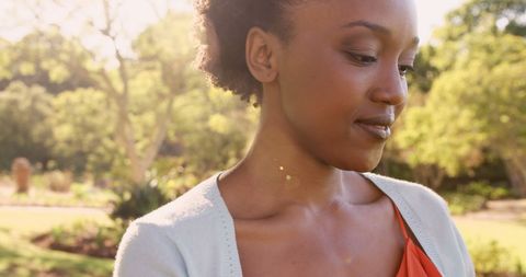 Serene Portrait of Smiling Woman Enjoying Sunny Park
