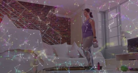 Woman Exercising at Home With Kettlebells and Digital Network Overlay