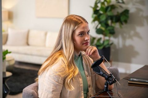 Young Woman Podcasting in Modern Living Room Working on Creative Project