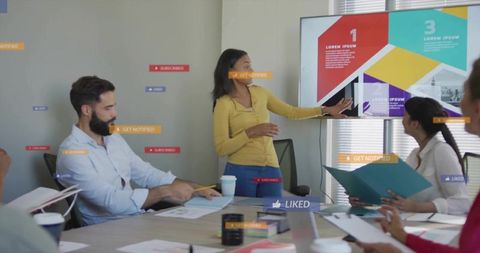 Team Collaborating While Woman Presenting Colorful Geometric Slide in Conference Room