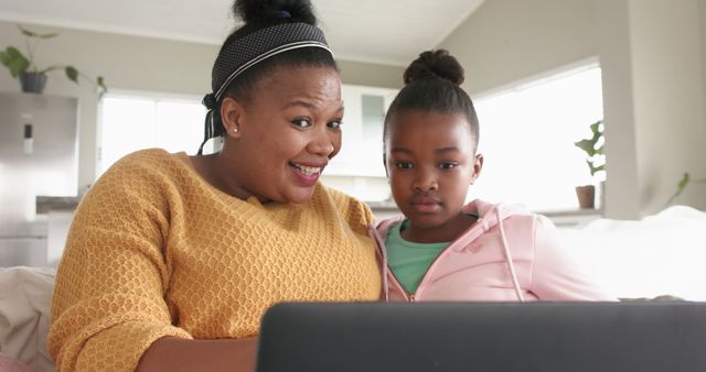 Mother and Daughter Using Laptop Together in Living Room - Download Free Stock Images Pikwizard.com