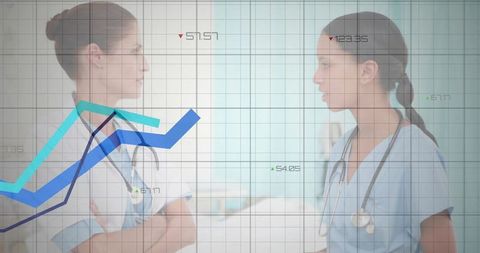 Two Medical Professionals Analyzing Chart in Hospital Corridor