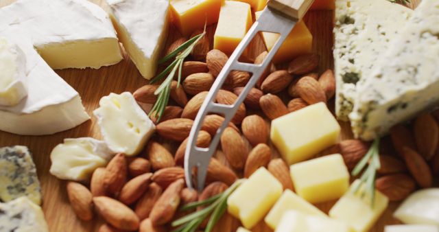 Assorted Cheeses and Almonds with Cheese Knife on Wooden Board - Download Free Stock Images Pikwizard.com