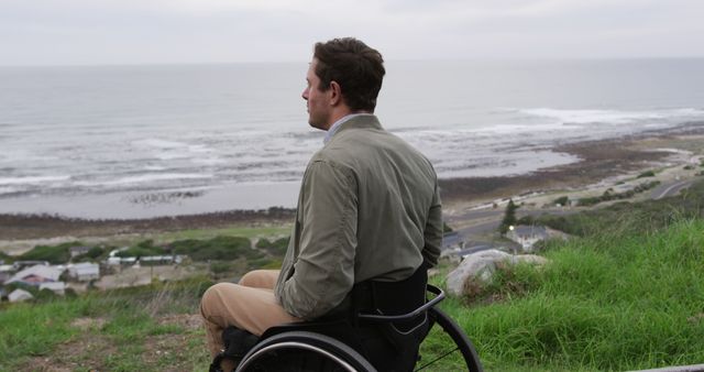 Man in Wheelchair Overlooking Scenic Ocean View - Download Free Stock Images Pikwizard.com