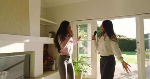 Diverse Friends Singing Karaoke in Bright Living Room