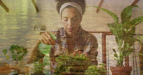 Woman Gardening with Spray Bottle Reflecting Tranquil Natural Scene